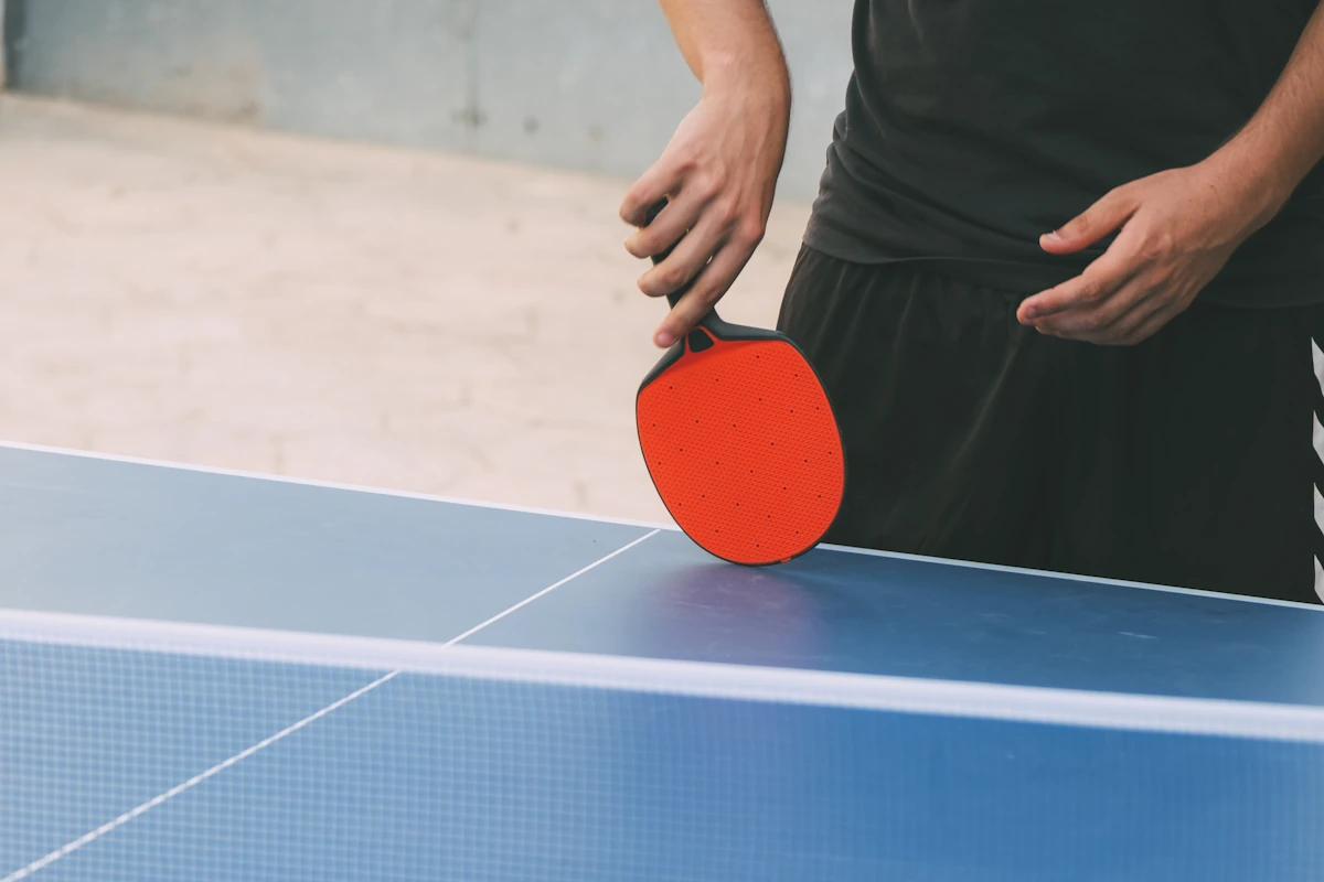 Un homme qui tient une raquette de ping pong